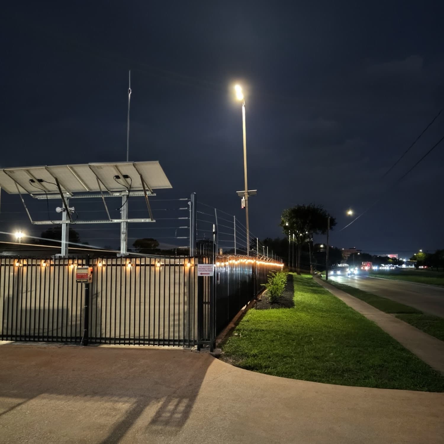 Electric-fenced, solar-powered, and well-lit perimeter around the Hobby Airport Parking lot at night, alongside a 24/7 staffed entry